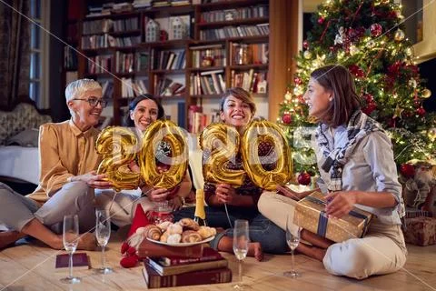 Family for New Year in front of a decorated x-mas tree Stock Photos