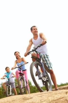 Family with one child cycling together Stock Photos