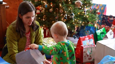 A family opening presents on christmas morning Stock Footage