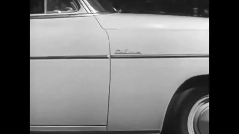 At a family picnic in 1950 a father uses tableware to build a model of a Stock Footage