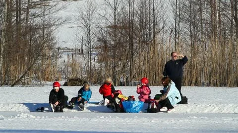 Family picnic on a winter lake Stock Footage