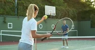 Family Playing Tennis On Summer Day At Sport Court. Mother In Pair With Father Stock Footage