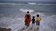 A Family Plays With The Waves On Marina Beach,Chennai,India Stock Footage