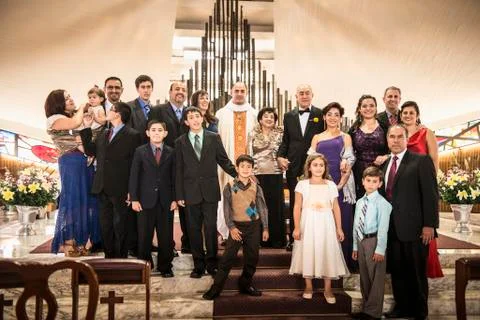 Family posing at wedding in church Stock Photos