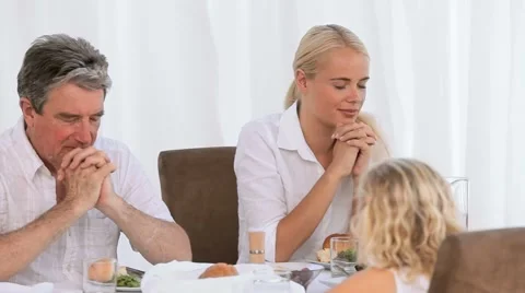 Family praying before dinner Stock Footage