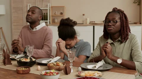 Family Praying Before Easter Dinner Stock Footage 148736471