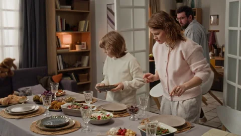 Family Preparing Dining Table and Setting Chairs for Dinner Stock Footage 340332629