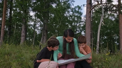Family reading map in forest Video stock 314969153