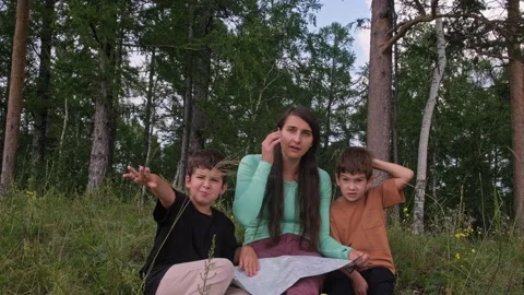 Family reading map in forest Stock Footage 314969295