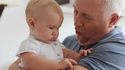 Family Relation of Elder 60s Man and Happy Baby Child. Wrinkled Skin of Grandfat Stock Footage 199479079