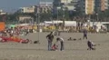 Family relaxing and walking on the sandy beach, Rimini, Italy, HD Footage