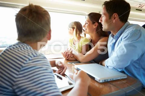 Family relaxing on train journey Stock Photos