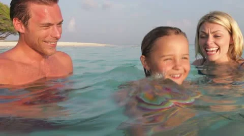 Family Relaxing In Tropical Sea Stock Footage