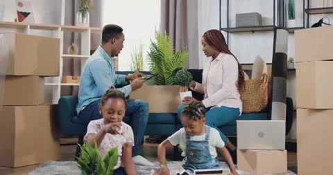 Family relocation concept where good-looking smiling happy african american Stock Footage 150645416