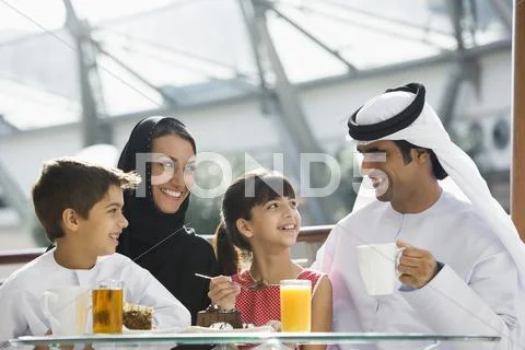 Family at restaurant eating dessert and smiling (selective focus) Stock-Fotos
