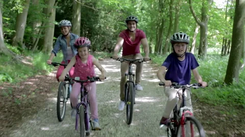 Family Riding Mountain Bikes Along Track Stock Footage