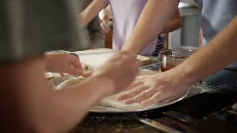Family rolling and preparing pizza dough at home in their kitchen Stock Footage 123733631