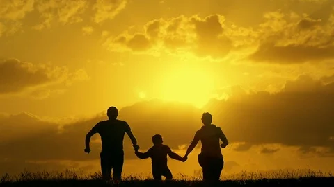 Family running at sunset and jumping up raising their hands winners Stock Footage 75617841