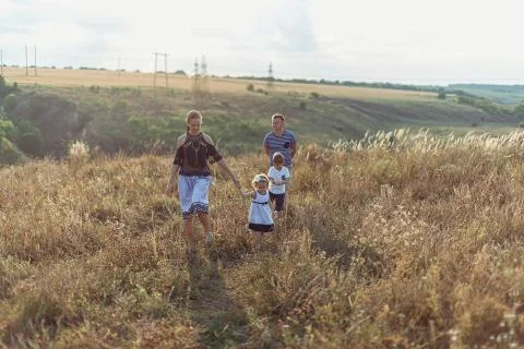 Family running through park in fall or autumn Stock Photos