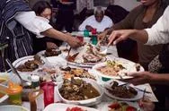 Family Serving Food At Holiday Dinner Stock Photos