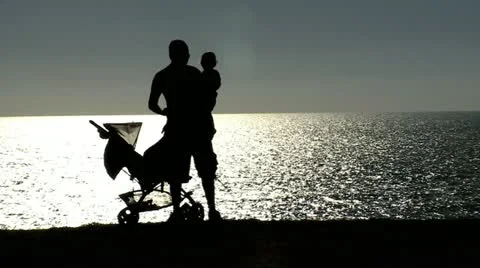 Family Shadow next to Ocean Stock Footage 10900745