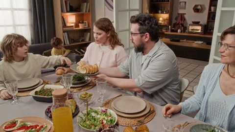 Family Sharing Bread and Having Dinner Together at Home Table Stock Footage 340337766