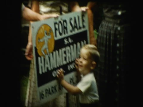 Family shows off "House for sale" sign Stock Footage