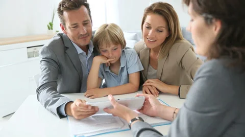 Family signing home purchase contract on tablet Stock Footage
