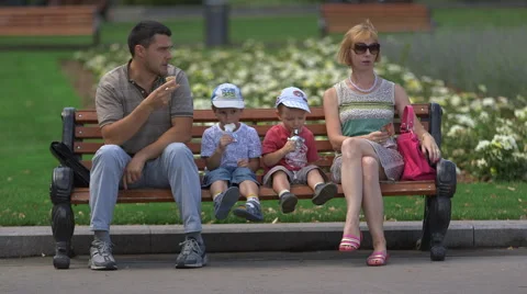 Family sitting on bench Stock Footage 41154259