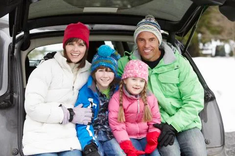 Family Sitting In Boot Of Car Wearing Winter Clothes Stock Photos