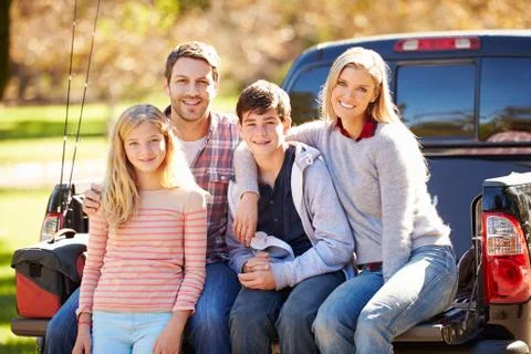 Family Sitting In Pick Up Truck On Camping Holiday Stock Photos