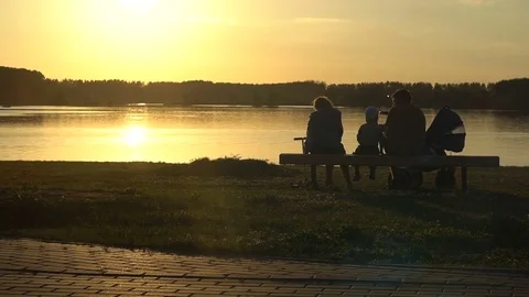 Family sitting on a sunset background Video stock 80362051