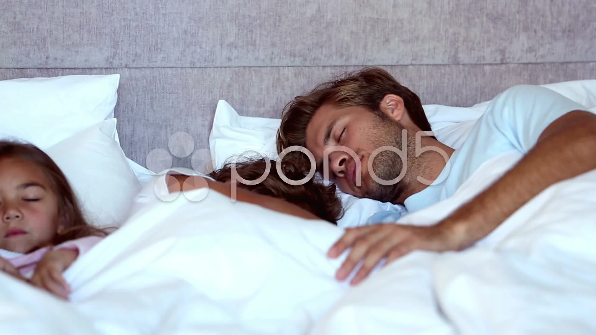 Family sleeping together in bed | Stock Video | Pond5