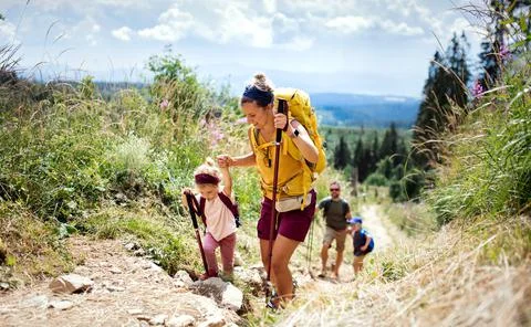 Family with small children hiking outdoors in summer nature, walking in High Stock Photos