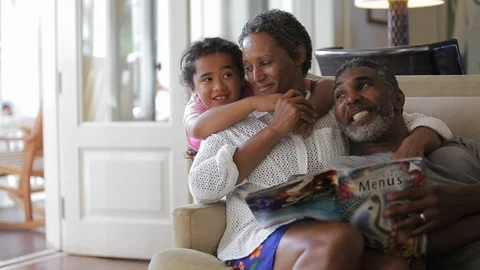 Family smiling on a sofa. Stock Footage 88367437