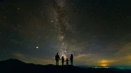 The Family Standing On The Mountain Against The Starry Sky. Time Lapse Stock Footage