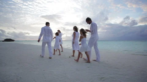 Family at sunset collecting shells Stock Footage 1055915