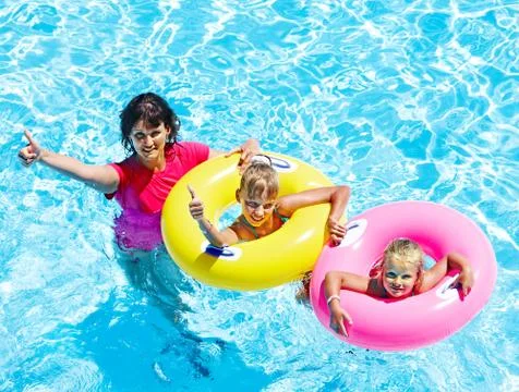 Family in swimming pool. Stock Photos