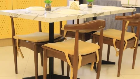Family table with Decor Props on top a native wooden modern chair on surfaces Stock Footage 160860778