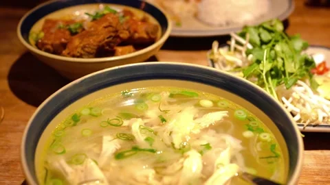 Family table enjoying Pho, authentic Vietnamese noodle dishe Stock Footage 326519067