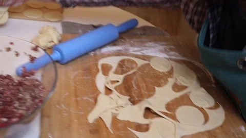 Family at the table in the kitchen making dumplings Stock Footage 276642776