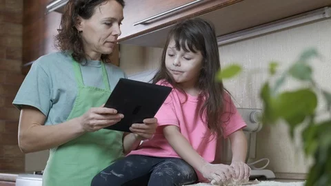 Family with a tablet in the kitchen. Stock Footage 106713003
