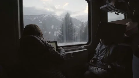 Family on tablets as train moves through the snowy mountains Stock Footage 134506420