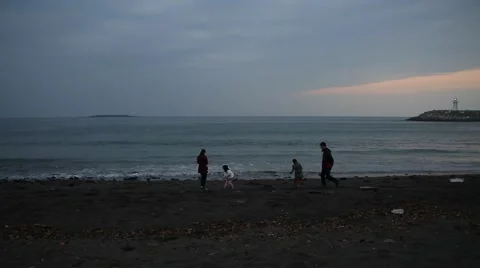 Family taking photos with smart phone on beautiful sand beach at sunset Stock Footage 59131733