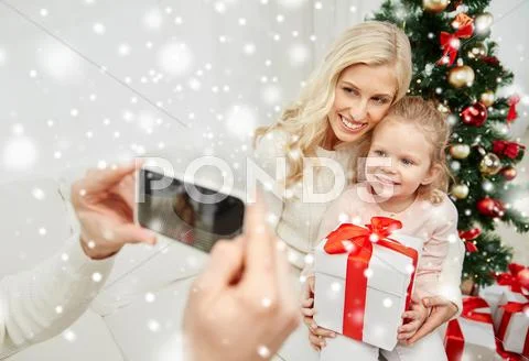 Family taking picture with smartphone at christmas Stock Photos