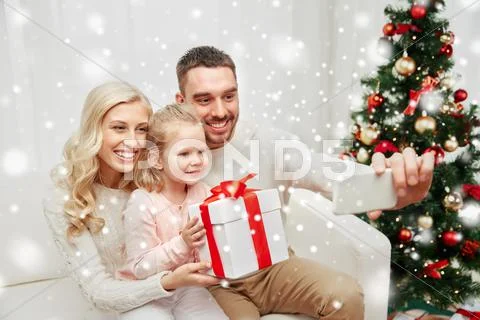 Family taking selfie with smartphone at christmas Stock Photos