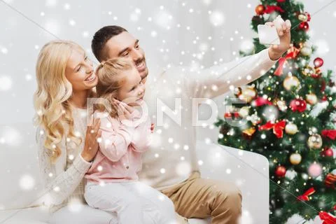Family taking selfie with smartphone at christmas Stock Photos