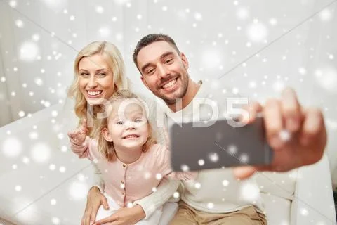 Family taking selfie with smartphone at home Stock Photos