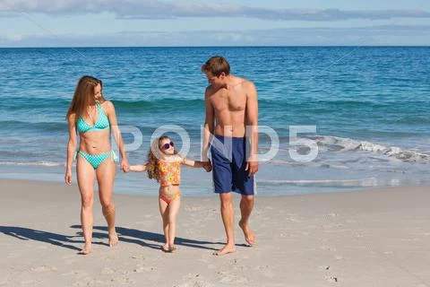 Family Taking A Walk On The Beach
