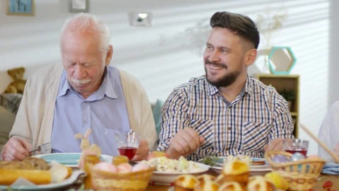 Family Talking and Smiling at Easter Dinner Stock Footage 106630745
